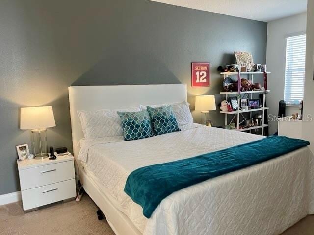 294 Captiva Dr, Davenport, FL 33896 - bedroom with light carpet and baseboards