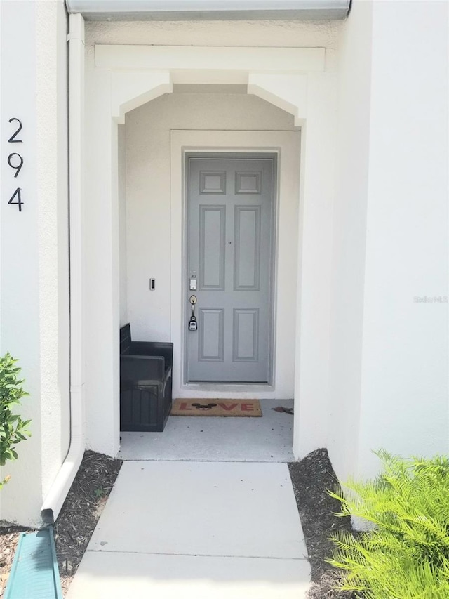 294 Captiva Dr, Davenport, FL 33896 - view of exterior entry with stucco siding