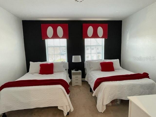 294 Captiva Dr, Davenport, FL 33896 - carpeted bedroom featuring multiple windows
