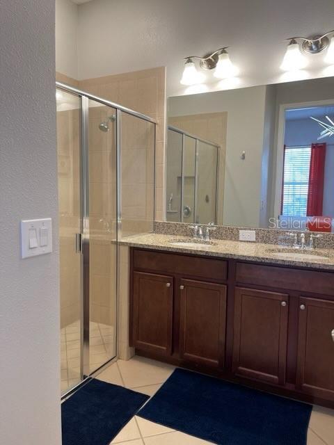 294 Captiva Dr, Davenport, FL 33896 - full bath featuring a stall shower, tile patterned floors, and double vanity
