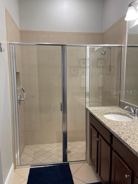 294 Captiva Dr, Davenport, FL 33896 - bathroom with vanity, a shower stall, and tile patterned flooring