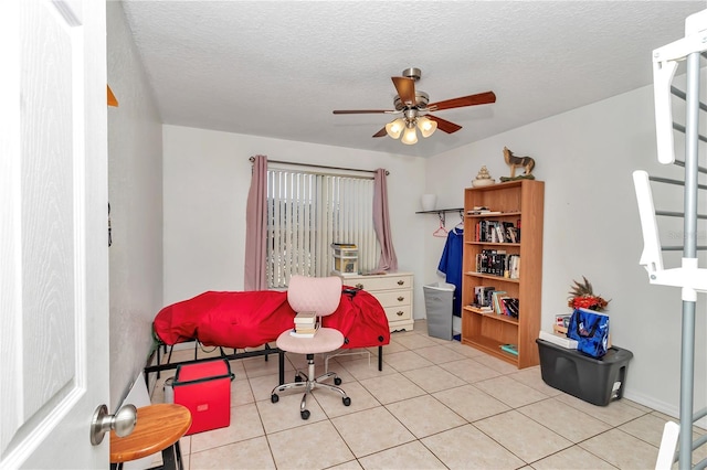 tiled home office with ceiling fan and a textured ceiling