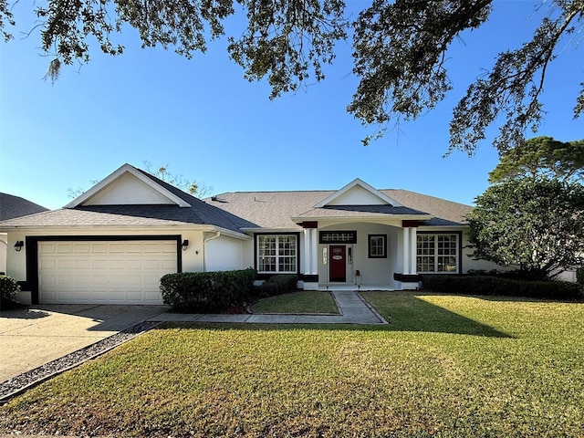 ranch-style home featuring a garage and a front lawn