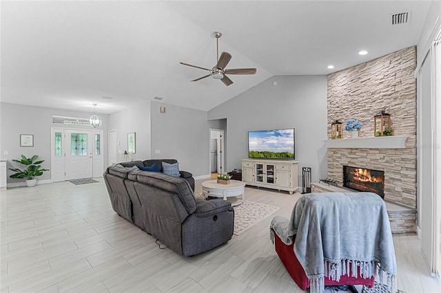 living room with ceiling fan, high vaulted ceiling, and a fireplace