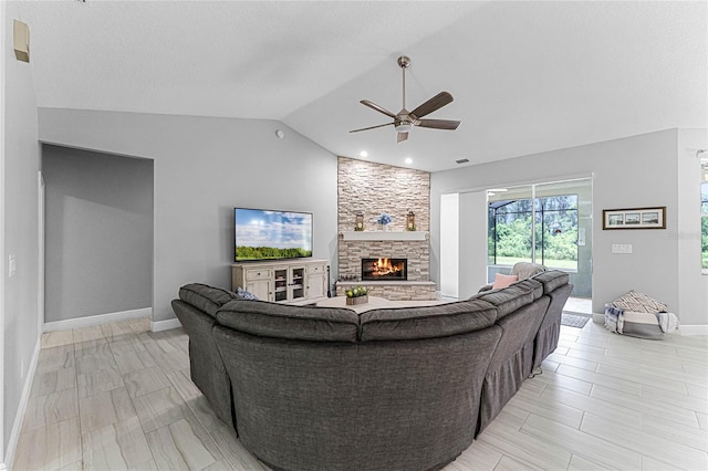 living room with a stone fireplace, lofted ceiling, and ceiling fan