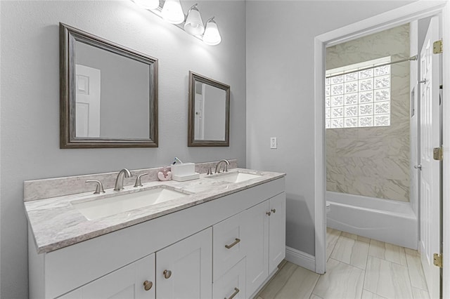 bathroom featuring vanity and tiled shower / bath