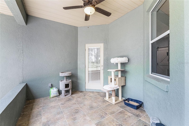 view of patio featuring ceiling fan and a balcony