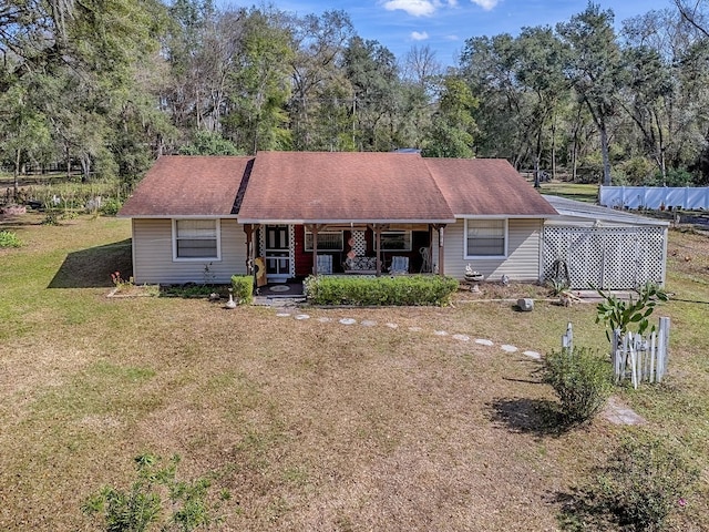 ranch-style home with a front yard and a porch