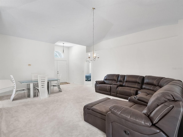 living area featuring a chandelier, vaulted ceiling, baseboards, and light colored carpet