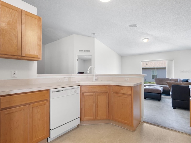 kitchen featuring dishwasher, open floor plan, a peninsula, light countertops, and a sink