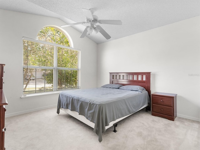 bedroom with light carpet, baseboards, vaulted ceiling, and a textured ceiling