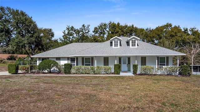 view of front of home with covered porch and a front yard