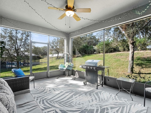 sunroom featuring ceiling fan