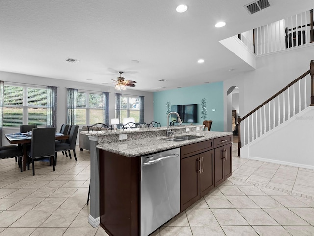 887 Daisy Hill Ct, Apopka, FL 32712 - kitchen featuring sink, dishwasher, a kitchen island with sink, light stone countertops, and light tile patterned flooring