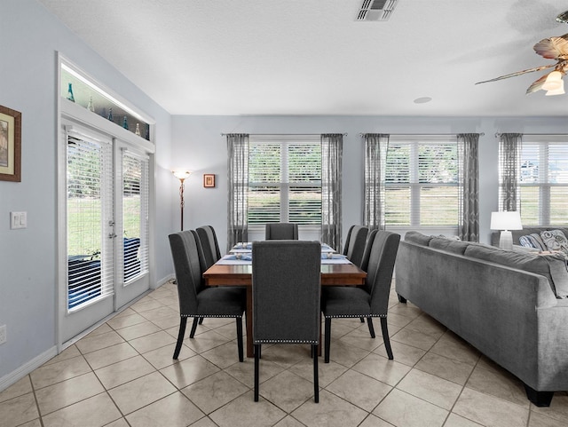887 Daisy Hill Ct, Apopka, FL 32712 - tiled dining area featuring plenty of natural light, a textured ceiling, ceiling fan, and french doors