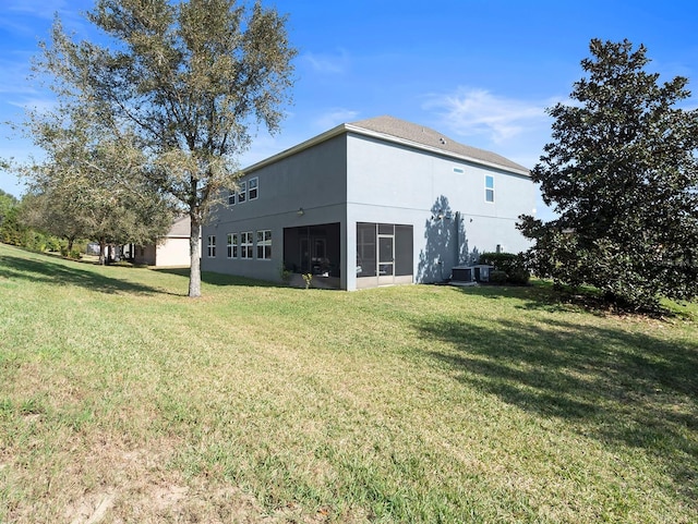 887 Daisy Hill Ct, Apopka, FL 32712 - rear view of property featuring central AC unit, a lawn, and a sunroom