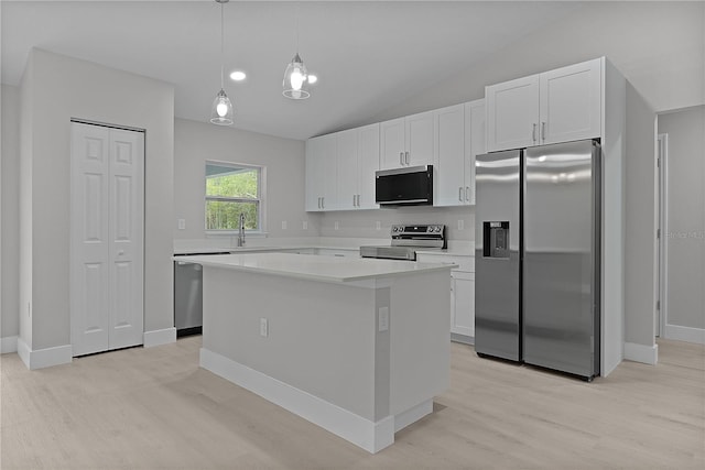 kitchen with white cabinetry, stainless steel appliances, a center island, and sink