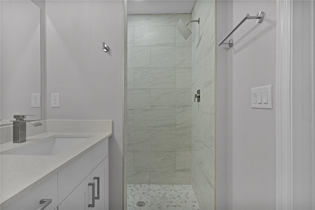 bathroom featuring vanity and tiled shower