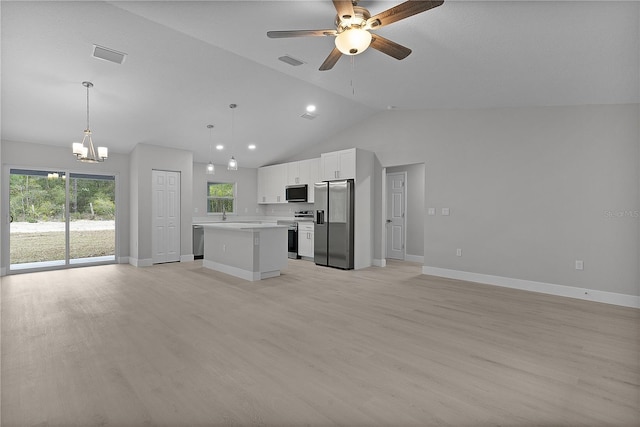 unfurnished living room featuring high vaulted ceiling, ceiling fan with notable chandelier, and light wood-type flooring