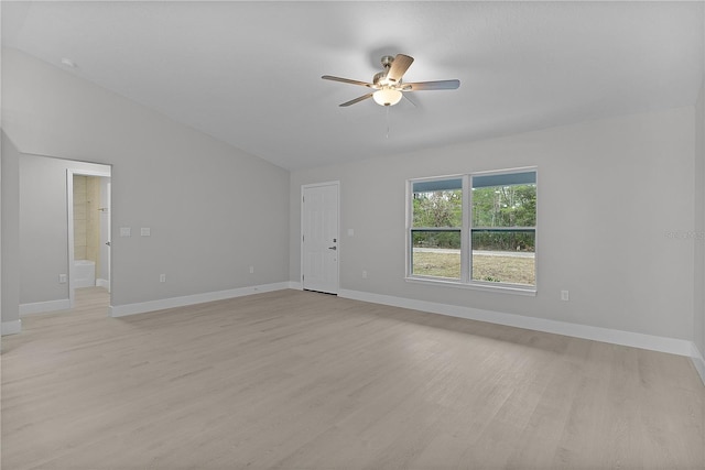 empty room with vaulted ceiling, ceiling fan, and light hardwood / wood-style flooring