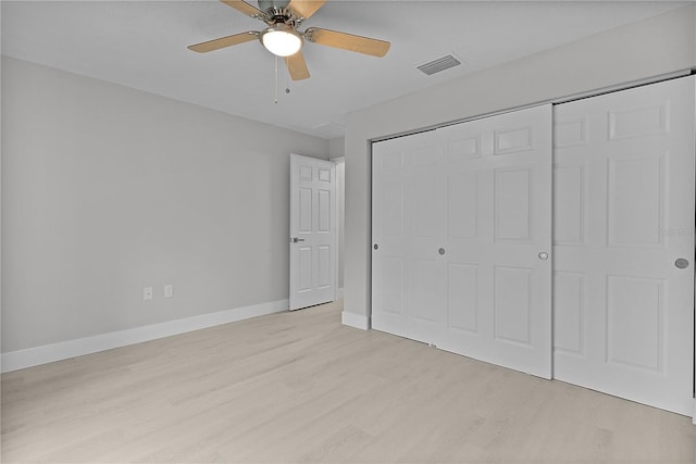 unfurnished bedroom featuring ceiling fan, light hardwood / wood-style floors, and a closet