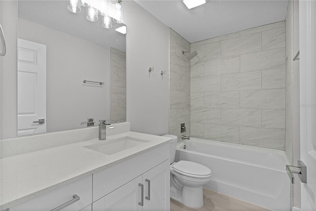 full bathroom featuring hardwood / wood-style flooring, vanity, a textured ceiling, toilet, and tiled shower / bath