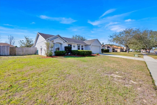 ranch-style home featuring a garage and a front yard