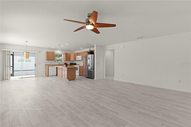 unfurnished living room with a ceiling fan, light wood-type flooring, baseboards, and recessed lighting