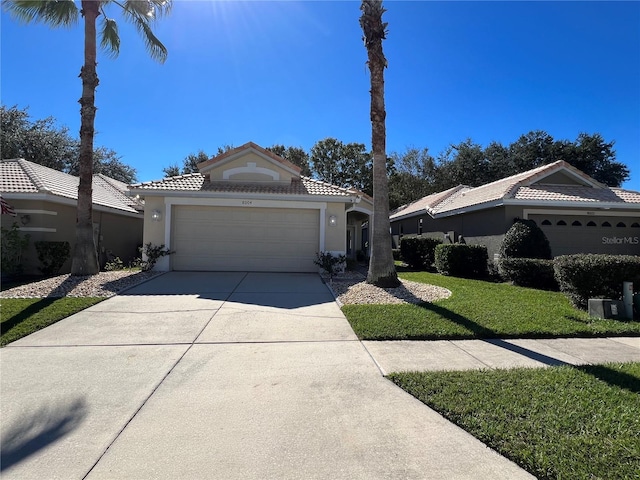 view of front of house with a garage and a front lawn