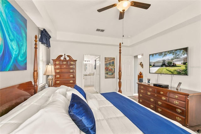 bedroom with a ceiling fan, visible vents, and ensuite bath