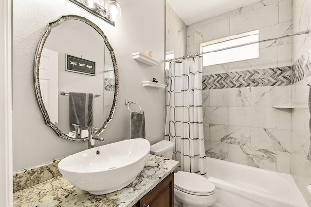 bathroom featuring toilet, shower / bath combo with shower curtain, and vanity