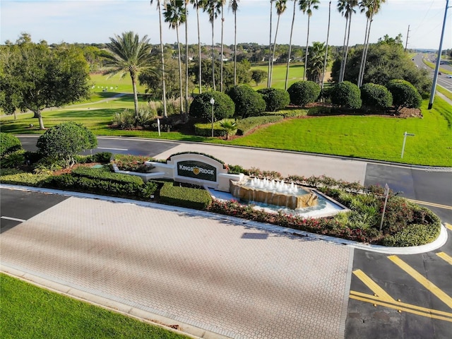 view of home's community featuring uncovered parking and a lawn