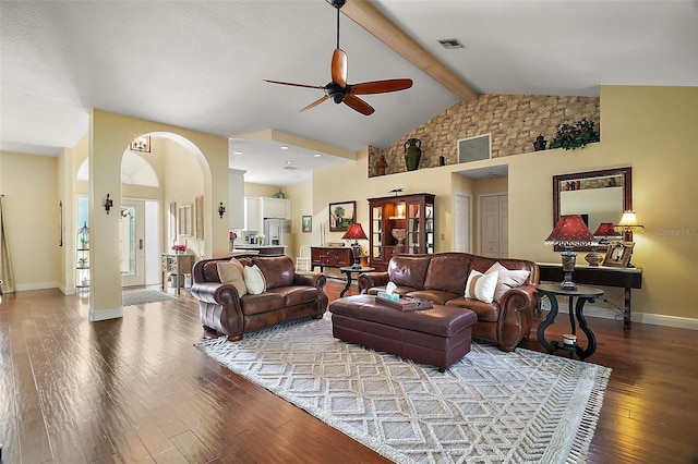 living room with ceiling fan, wood-type flooring, high vaulted ceiling, and beamed ceiling