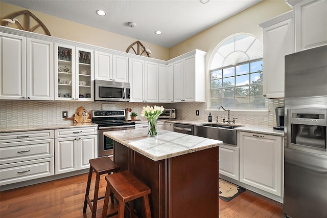 kitchen with sink, stainless steel appliances, and white cabinets