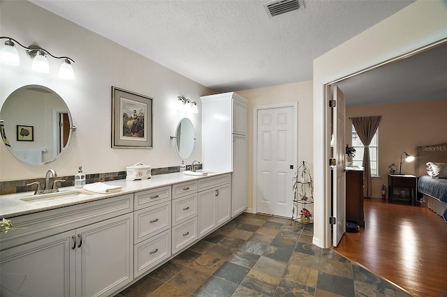 bathroom featuring vanity and a textured ceiling