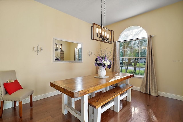 dining area with dark hardwood / wood-style flooring, a notable chandelier, and a healthy amount of sunlight