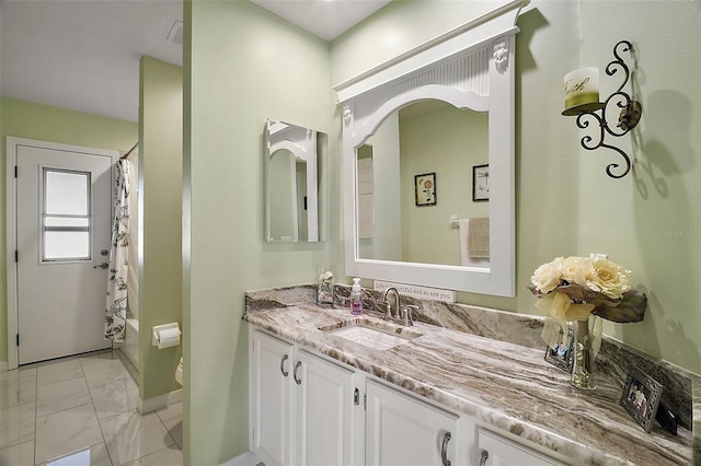 full bathroom with vanity, shower / tub combo with curtain, and toilet