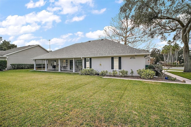 rear view of property featuring a patio area and a lawn