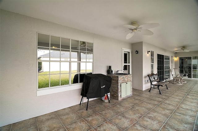 view of patio featuring an outdoor kitchen, ceiling fan, and area for grilling