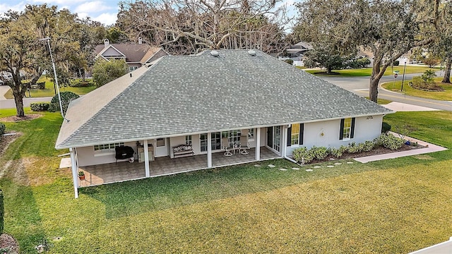 view of front of house with a patio and a front yard