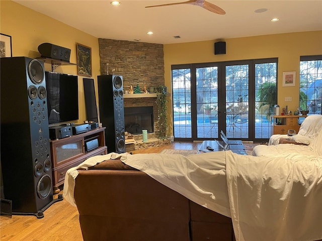 living area featuring light wood finished floors, visible vents, a ceiling fan, a fireplace, and recessed lighting