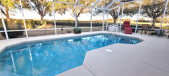 view of swimming pool with a patio and glass enclosure