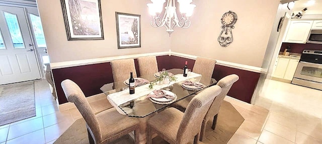 dining area with an inviting chandelier and light tile patterned floors