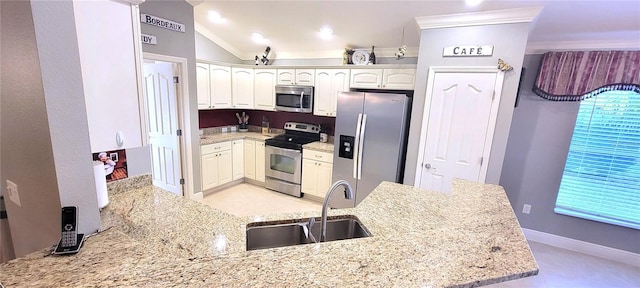 kitchen featuring appliances with stainless steel finishes, kitchen peninsula, sink, and light stone countertops