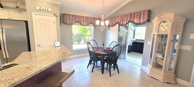 dining space with vaulted ceiling, light tile patterned floors, and a chandelier