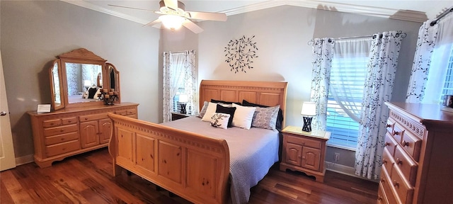 bedroom featuring dark hardwood / wood-style flooring, ornamental molding, and ceiling fan