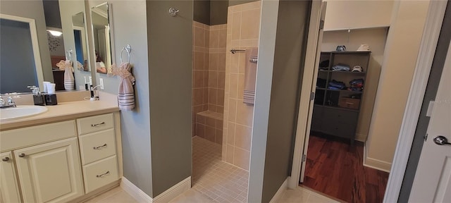 bathroom featuring vanity, tiled shower, and tile patterned floors