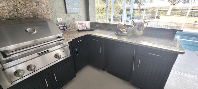 view of patio / terrace featuring exterior kitchen and a grill