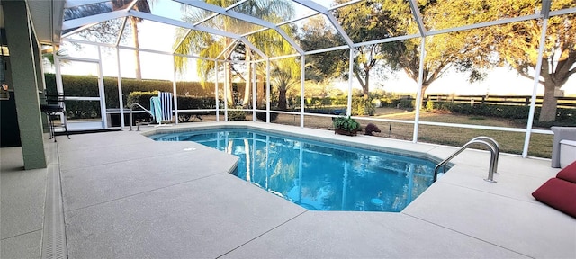 view of swimming pool with a patio and glass enclosure