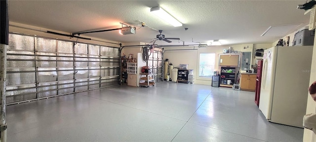 garage featuring white refrigerator and a garage door opener